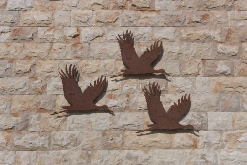Ferienhaus Außenansicht Wandverzierung Kraniche